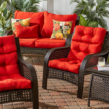 Wicker Woven Lounge Set with Bright Red Cushions and Floral Accent Pillows