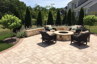 Design ideas for a large traditional back patio in DC Metro with a fire feature and concrete paving.