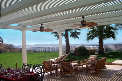 Example of a mid-sized island style backyard patio design in San Diego with a pergola