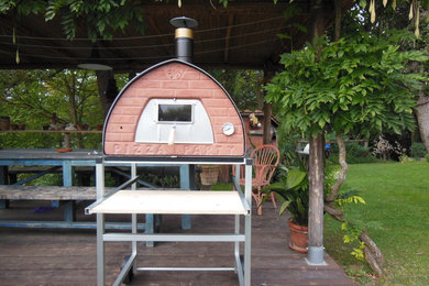 Large tuscan backyard patio kitchen photo in Florence