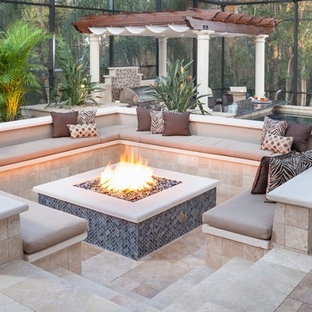 Patio - mid-sized transitional backyard stone patio idea in Tampa with a fire pit and a pergola