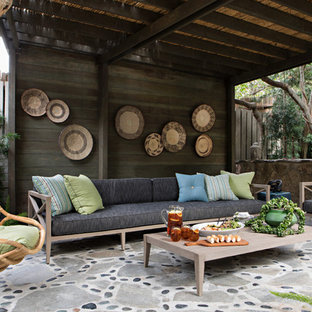 Inspiration for a coastal stone patio remodel in Orange County with a gazebo