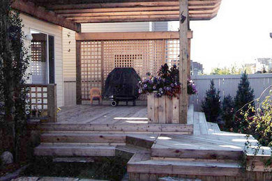 Patio container garden - small backyard patio container garden idea in Calgary with a pergola and decking