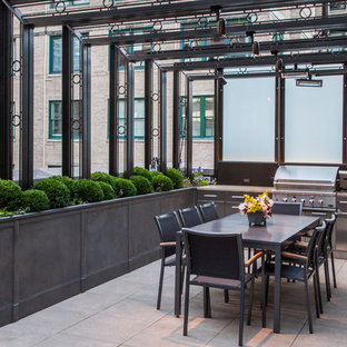 Photo of a traditional patio in Chicago with an outdoor kitchen and an awning.