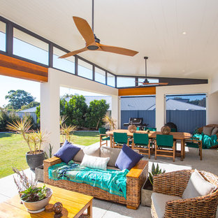 Contemporary backyard patio in Brisbane with concrete slab and a roof extension.
