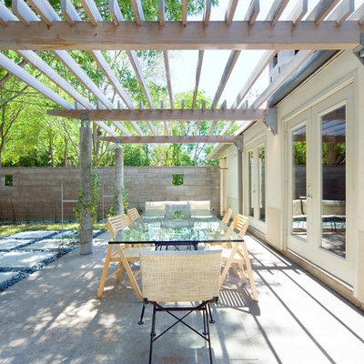 Patio - contemporary concrete patio idea in Dallas with a pergola
