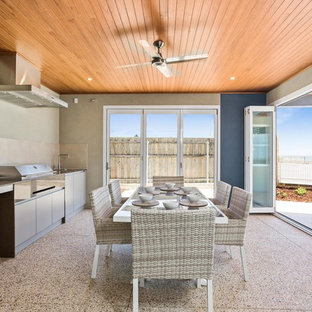 This is an example of a mid-sized beach style patio in Perth with an outdoor kitchen and a roof extension.