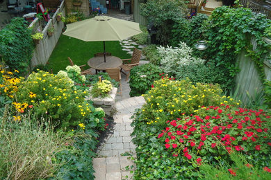 This is an example of a small traditional backyard brick landscaping in Toronto.