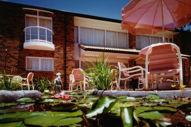 Patio - large tropical courtyard patio idea in Gold Coast - Tweed
