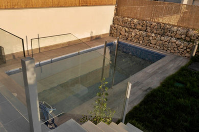 Diseño de casa de la piscina y piscina alargada moderna de tamaño medio rectangular en patio delantero con entablado