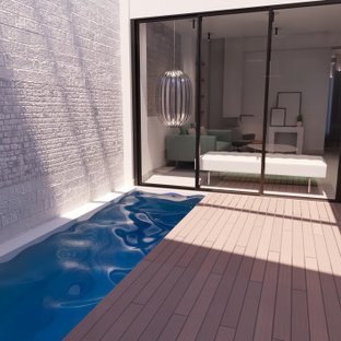 Ispirazione per una piccola piscina coperta monocorsia minimalista rettangolare con pedane