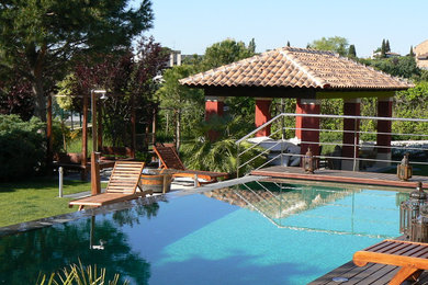 Imagen de casa de la piscina y piscina alargada de estilo zen de tamaño medio rectangular con entablado
