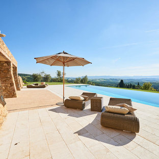 Immagine di una piscina a sfioro infinito mediterranea rettangolare dietro casa