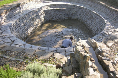 Imagen de casa de la piscina y piscina natural campestre grande a medida en patio delantero con adoquines de piedra natural