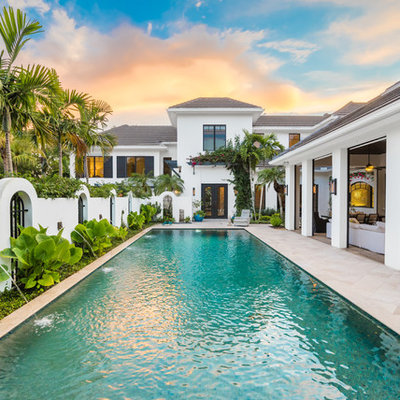 Inspiration for a tropical backyard tile and rectangular lap pool remodel in Miami