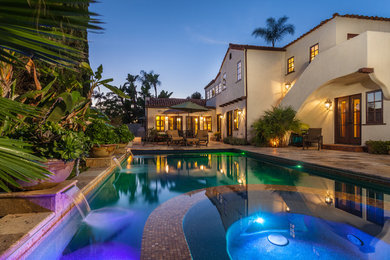 Hot tub - large mediterranean backyard rectangular and stone lap hot tub idea in San Diego