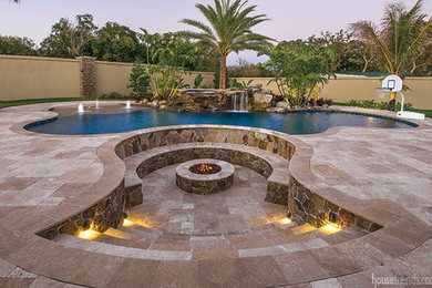 Huge island style backyard stone and kidney-shaped natural hot tub photo in Tampa