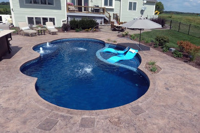 Foto de piscina clásica de tamaño medio a medida en patio trasero