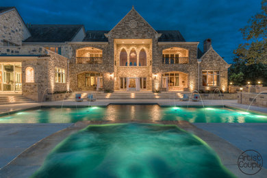 Inspiration for a large victorian backyard stone and rectangular hot tub remodel in Austin