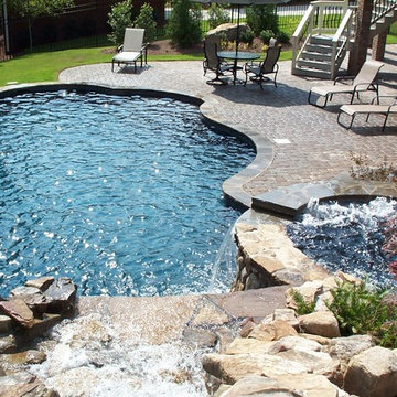 A Craftsman Pool with Spa and Waterfall Features