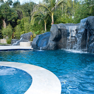 Inspiration for a mid-sized mediterranean backyard concrete paver and custom-shaped natural water slide remodel in Los Angeles