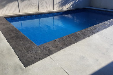 Example of a small classic backyard concrete paver and rectangular pool design in Vancouver