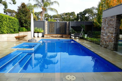 Свежая идея для дизайна: большой прямоугольный бассейн на заднем дворе в классическом стиле с джакузи и мощением тротуарной плиткой - отличное фото интерьера