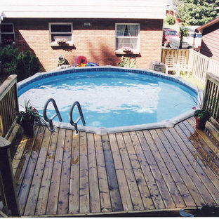 Foto di una piscina fuori terra chic rotonda dietro casa e di medie dimensioni con pedane