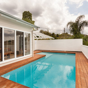Design ideas for a mid-sized beach style rooftop l-shaped aboveground pool in Other with decking.