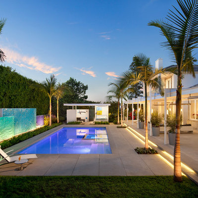 Example of a large trendy backyard rectangular and concrete paver lap pool design in Los Angeles