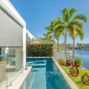 Photo of a mid-sized modern backyard l-shaped pool in Sunshine Coast.