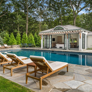 Elegant stone and rectangular pool house photo in New York