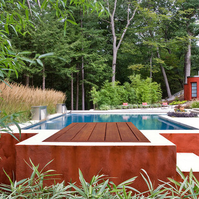 Large trendy backyard concrete and rectangular lap hot tub photo in Boston
