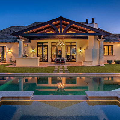 Large elegant backyard stone and rectangular hot tub photo in Phoenix