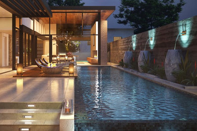 Modelo de piscina infinita moderna grande rectangular en patio trasero con suelo de baldosas