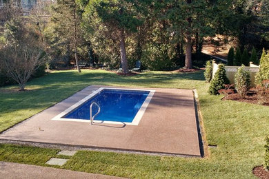 Inspiration for a large timeless backyard concrete and rectangular lap pool remodel in Other