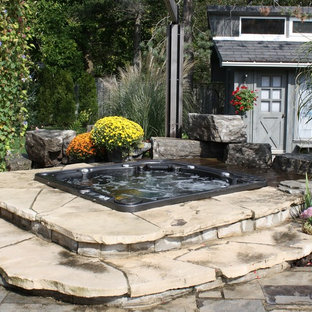 Design ideas for a small country backyard rectangular pool in Toronto with a hot tub and natural stone pavers.