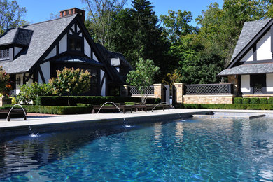 Large elegant backyard stone and rectangular pool fountain photo in Cleveland