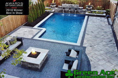 Inspiration for a mid-sized transitional backyard concrete paver and rectangular natural pool fountain remodel in Toronto