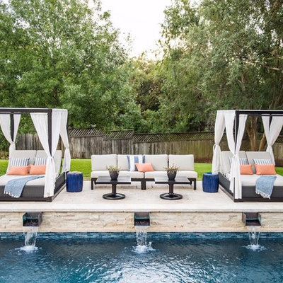 Large transitional backyard concrete paver pool fountain photo in Austin