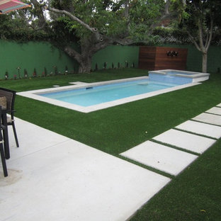 Photo of a small modern backyard rectangular lap pool in Los Angeles with a hot tub and concrete pavers.