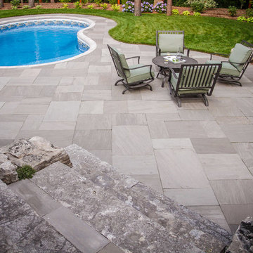 Backyard landscaping with flagstone patio in Aurora.