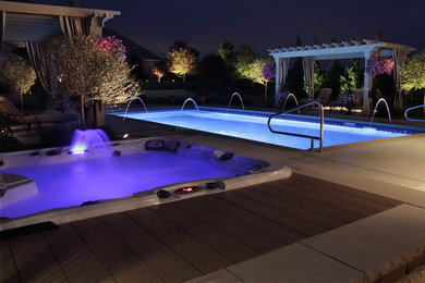 Inspiration for a large contemporary backyard rectangular natural hot tub remodel in Milwaukee with decking