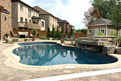Large minimalist backyard concrete paver and custom-shaped pool fountain photo in Toronto