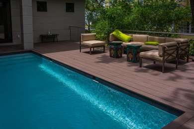 Example of a small minimalist rectangular pool design in Tampa with decking