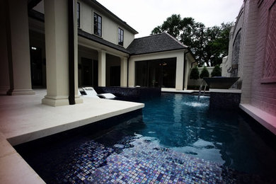 Inspiration for a large contemporary back custom shaped hot tub in New Orleans with tiled flooring.
