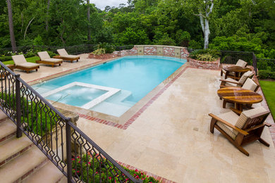 Pool fountain - large traditional backyard stone and rectangular pool fountain idea in Houston