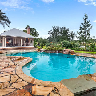 Pool house - coastal backyard kidney-shaped pool house idea in New Orleans