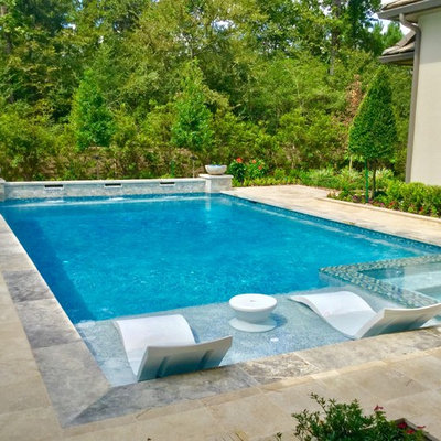 Example of a large transitional backyard stone and rectangular lap pool fountain design in Houston