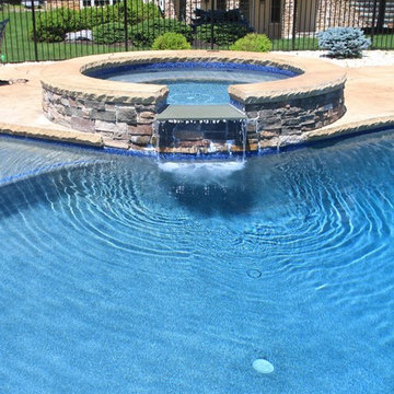 Beautiful Custom Freeform style salt water pool with raised spa